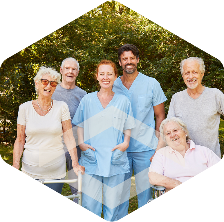 Caregiver embracing an elderly resident in a garden