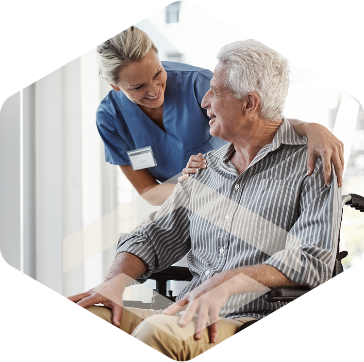 Caregiver embracing an elderly resident during hospice care