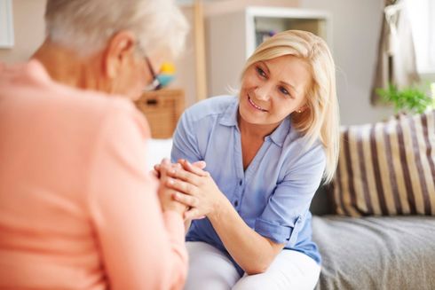 Caregiver assisting an elderly man