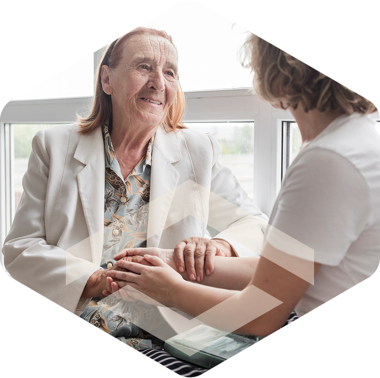Caregiver supporting an elderly woman during respite care